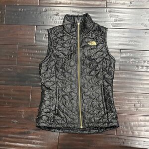 The North Face Black Quilted Vest with Gold Accents
